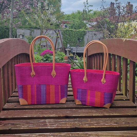 Magenta coloured raffia baskets with bright stripes