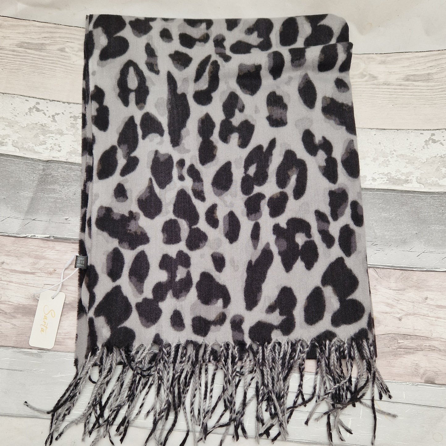 Leopard print scarf in colours of white, grey and black.
