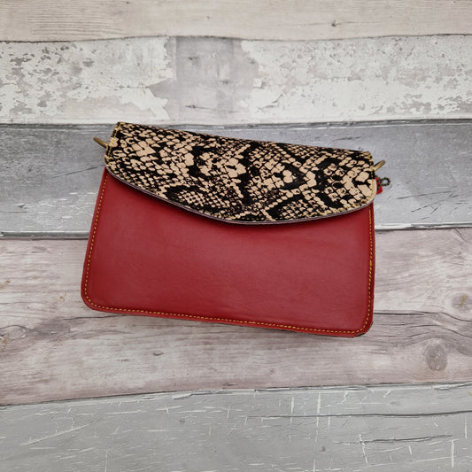 Red Leather clutch bag with a snakeskin print textured envelope style panel.