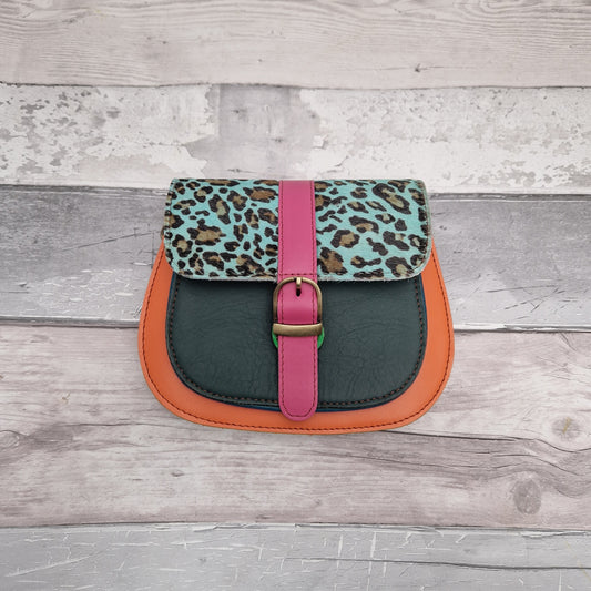Saddle bag style, made from leather off cuts in bright colours with a textured panel of leopard print in blue.