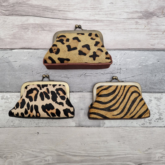 Leather purses made from textured cow hide, painted to resemble animal print.