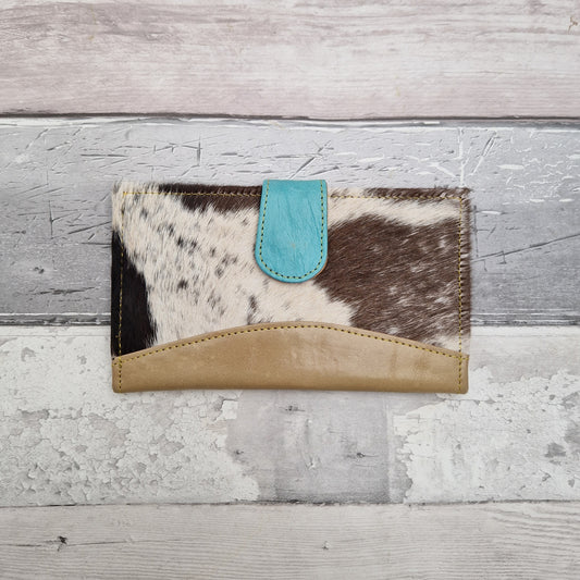 All leather purse made from off cuts in a variety of coloured pieces. Covered in textured cow hide.