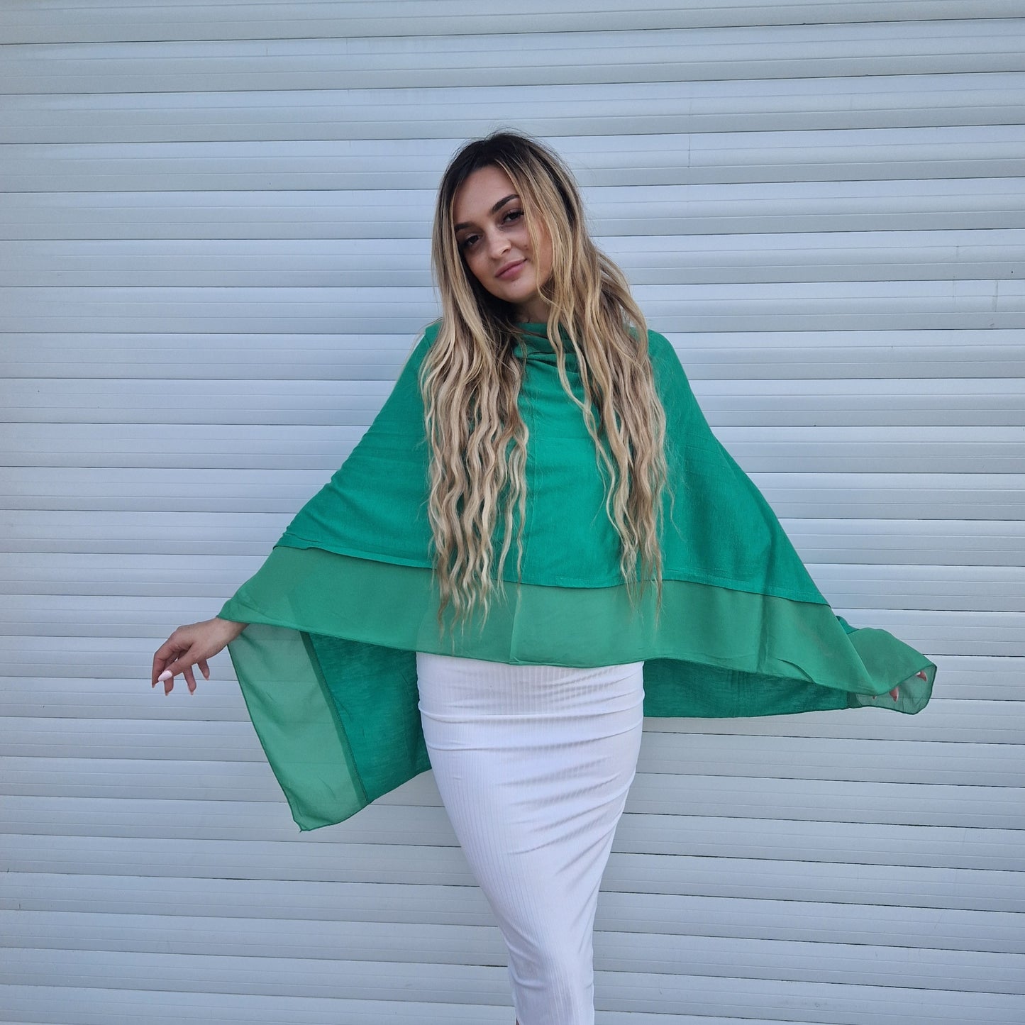 Young woman wearing an Emerald Green Poncho with a chiffon trim.