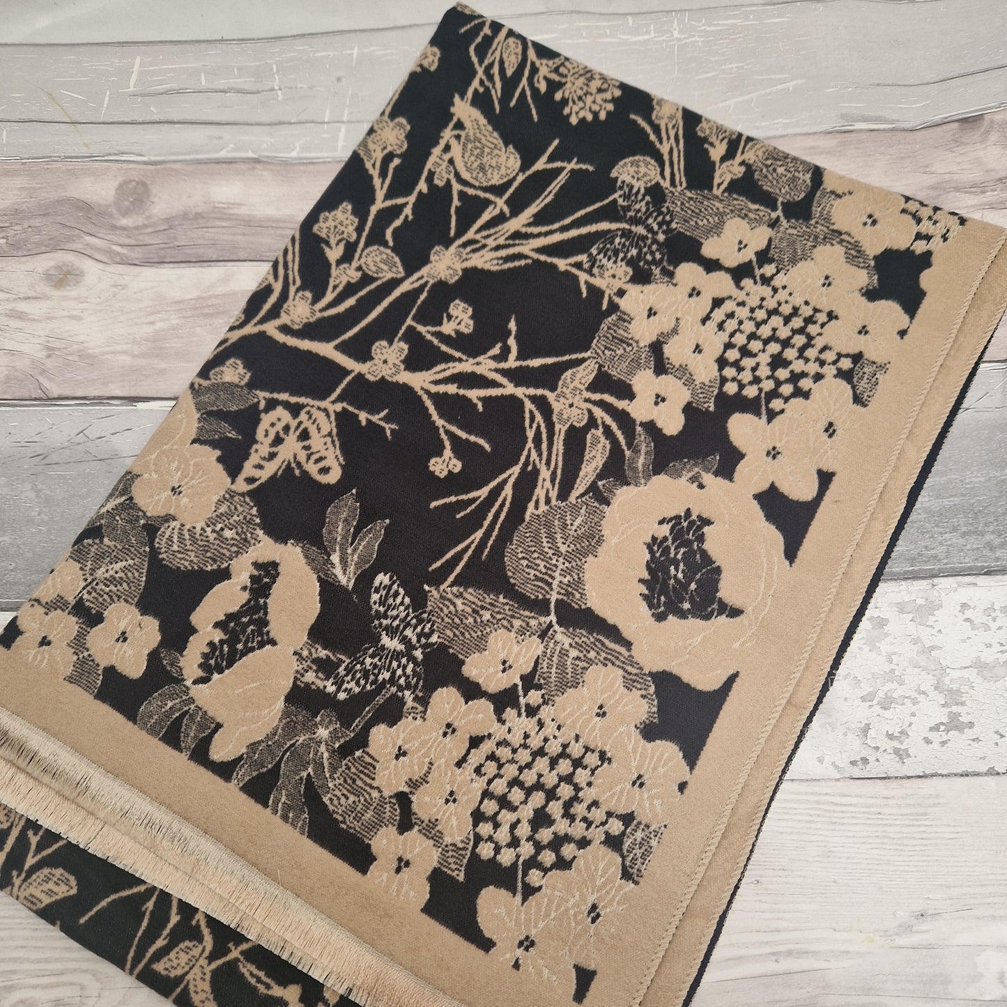 Black and Beige coloured scarf featuring a hedgerow scene of branches, birds and butterflies.