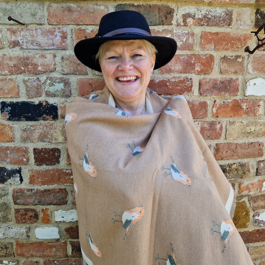 Lady wrapped in a coffee coloured scarf with Robin decoration.