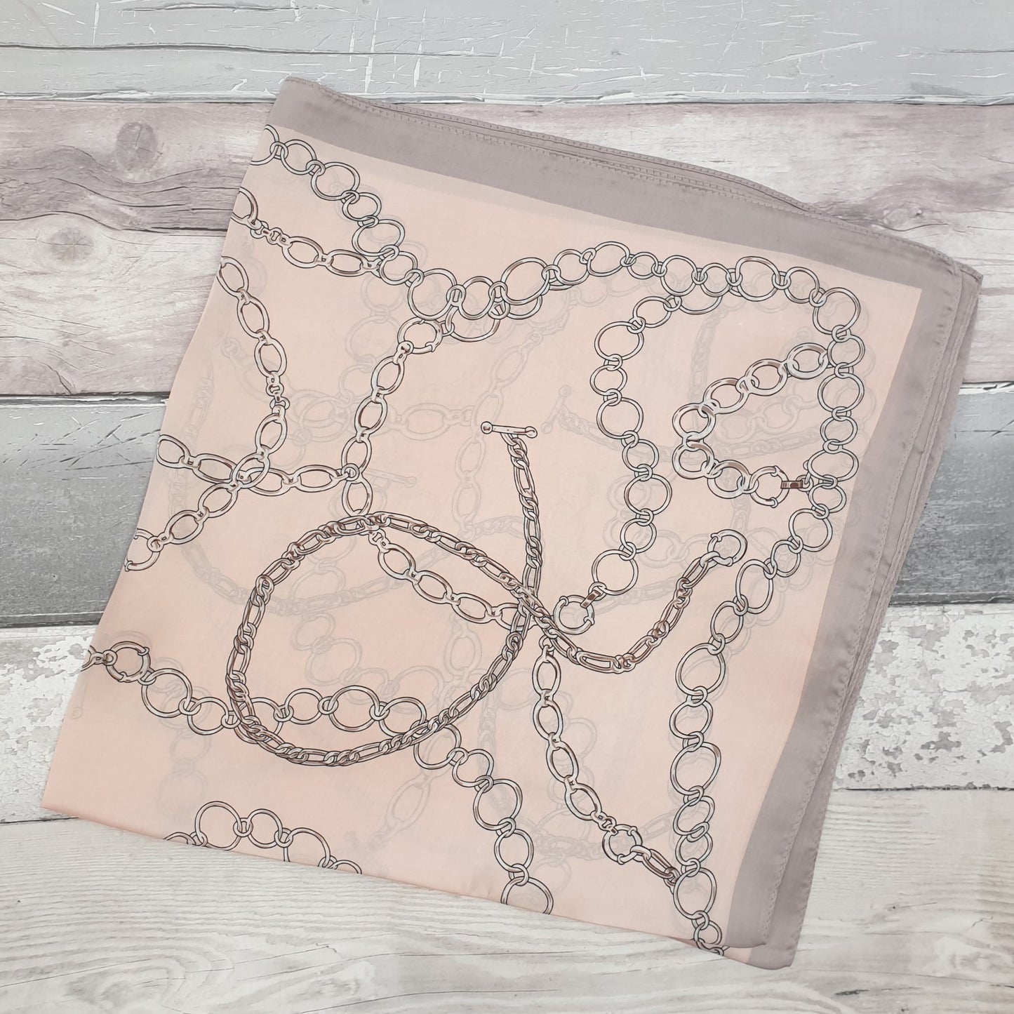 Pale pink designer inspired scarf with large link chain pattern.