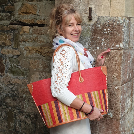 Lady carrying a red raffia basket