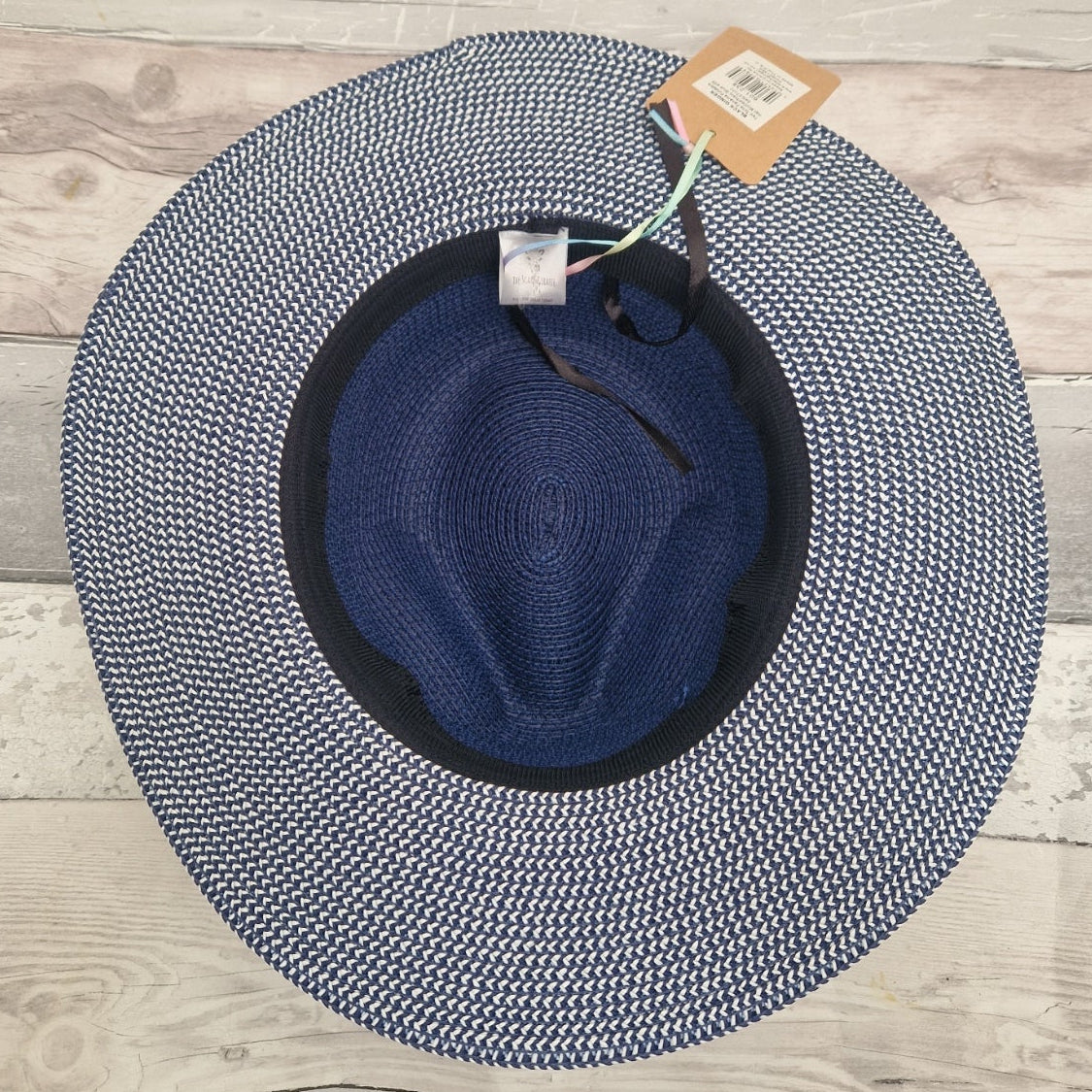Inside view of a blue Panama hat with adjustable band visible in the crown rim.