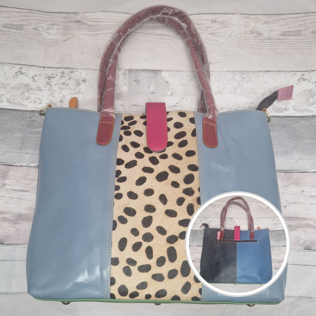 All leather tote bag in sky blue with a textured panel down the centre in a black and white spot print.