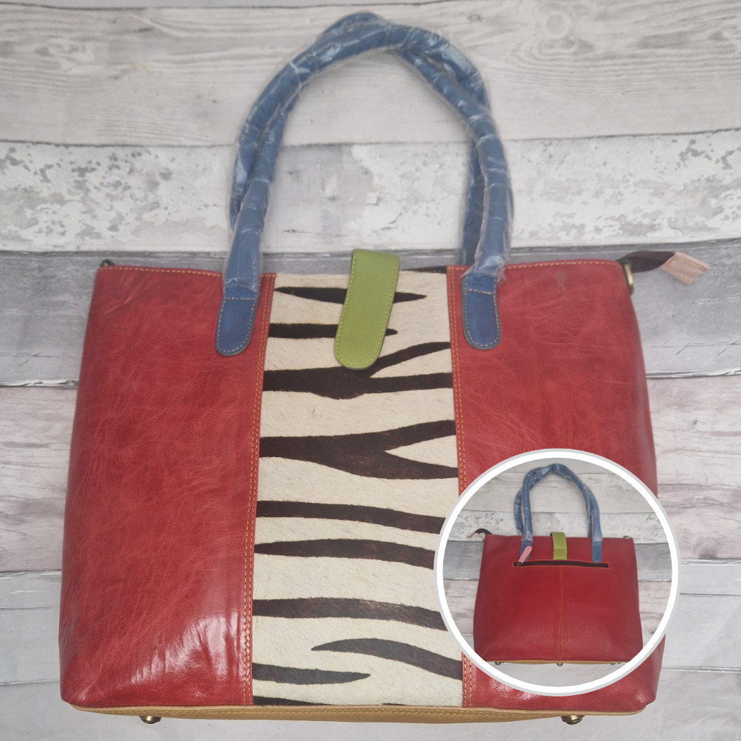All leather tote bag in red with a textured panel down the centre in a zebra print.