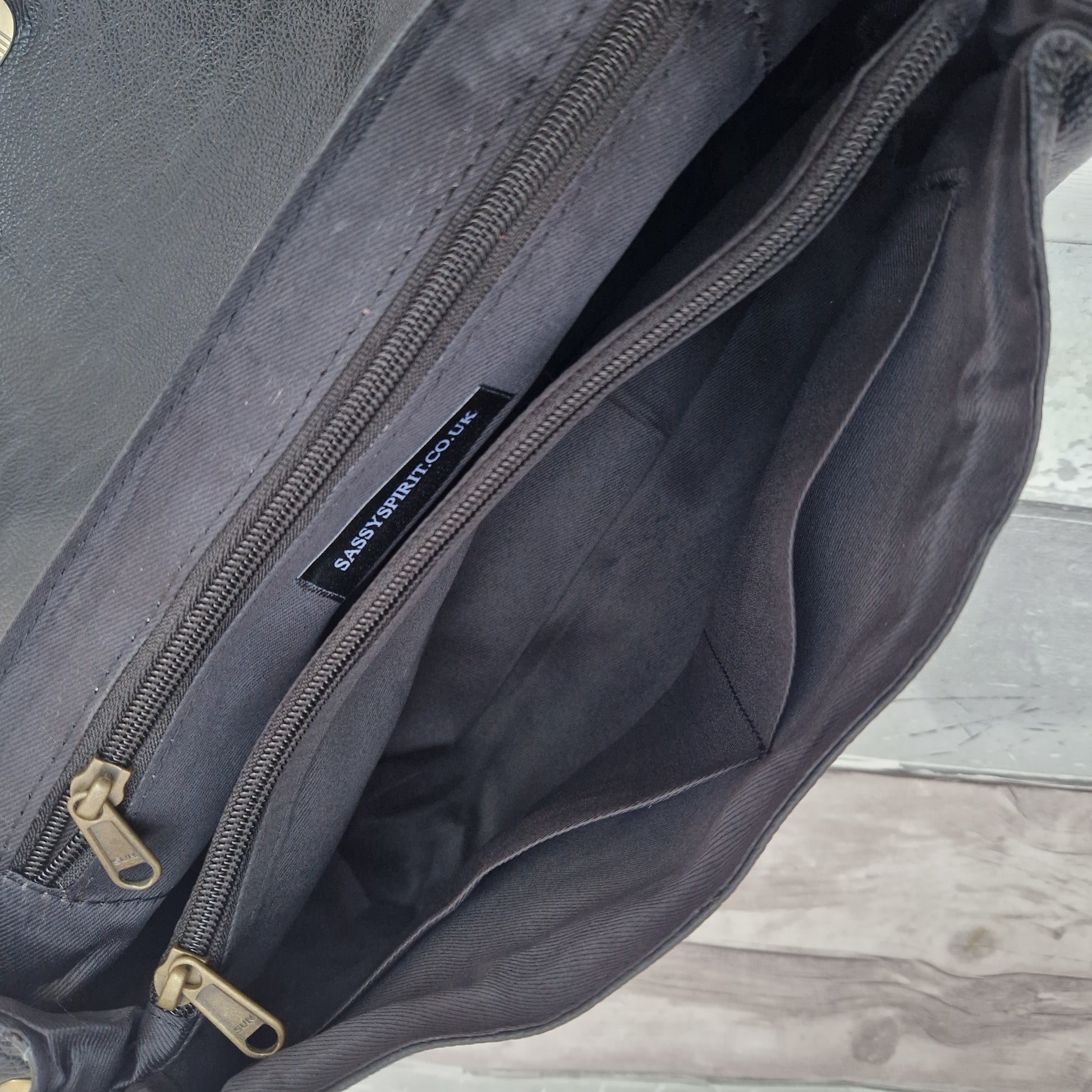 Inside view of Sassy Spirit Adhira black leather baguette shaped bag.