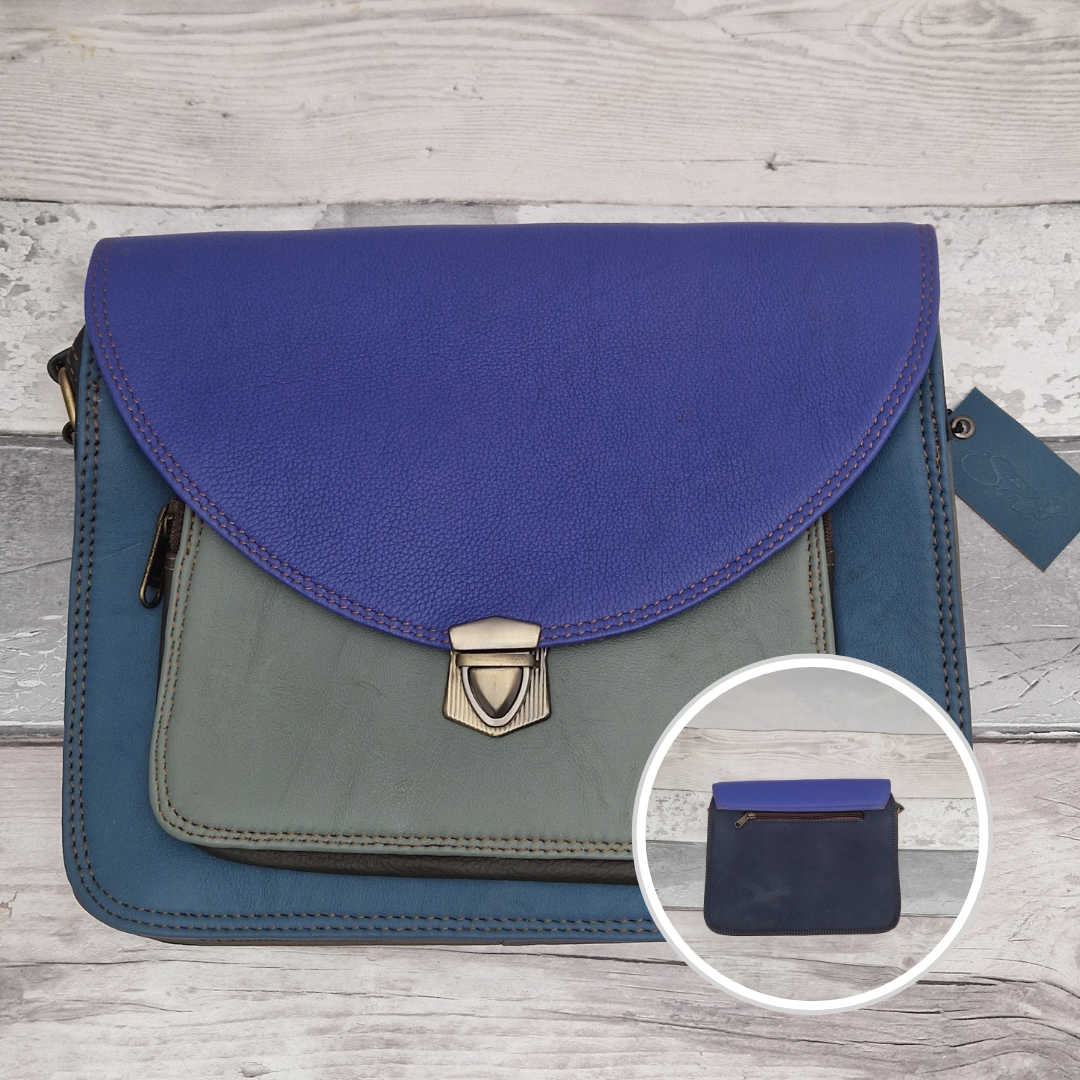 Two-tone blue and gray handbag with a close-up inset on a wooden surface