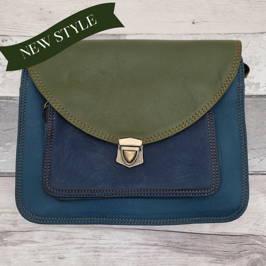 Two-toned green and blue leather bag on a wooden surface with 'NEW STYLE' text.