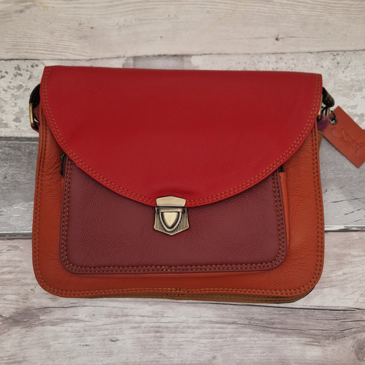 Red leather satchel style crossbody bag with a push lock clasp.