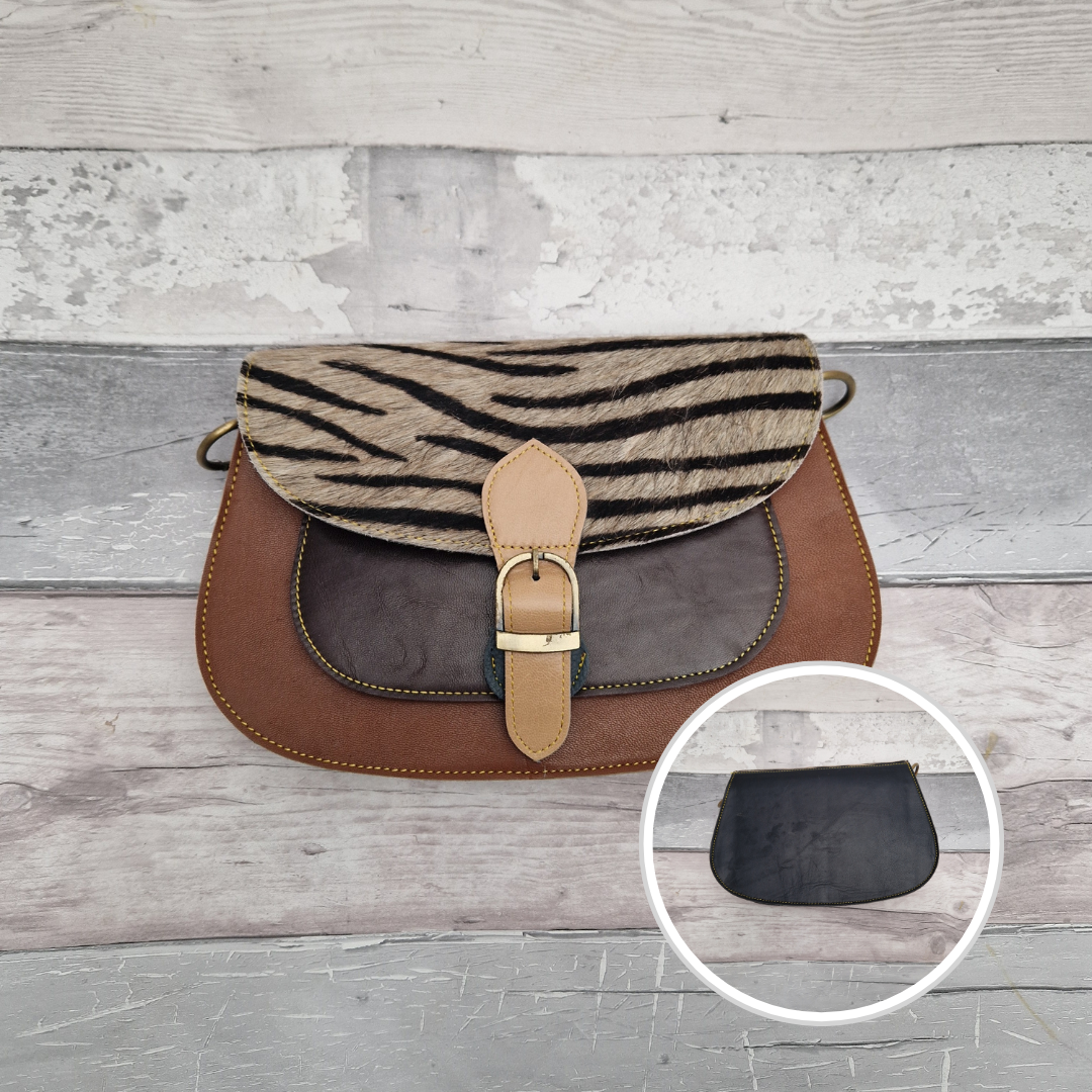 Scalloped shaped all leather bag in tan brown with a textured panel of zebra print.