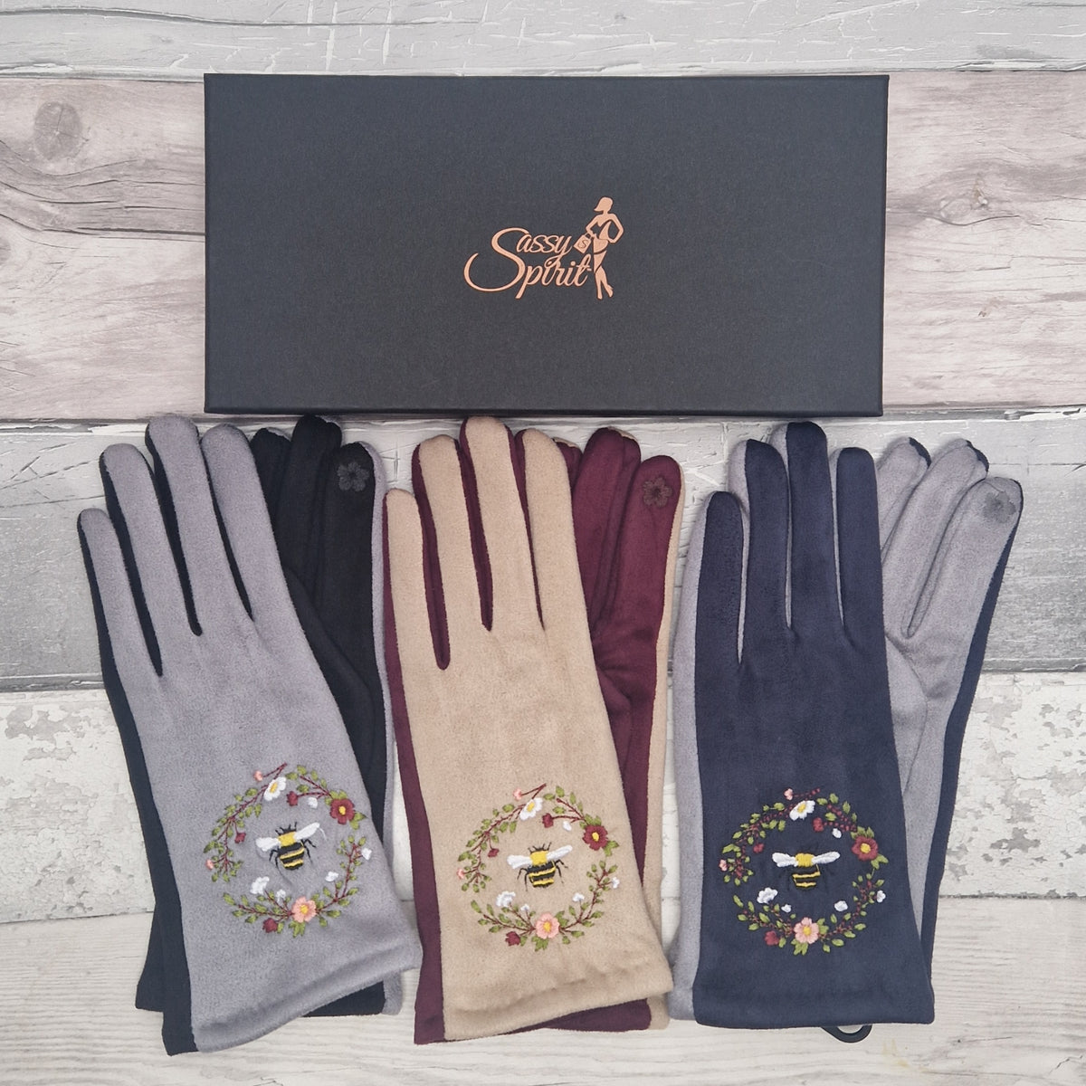 Set of three pairs of gloves with embroidered bee designs with a branded 'Sassy Spirit' gift box.