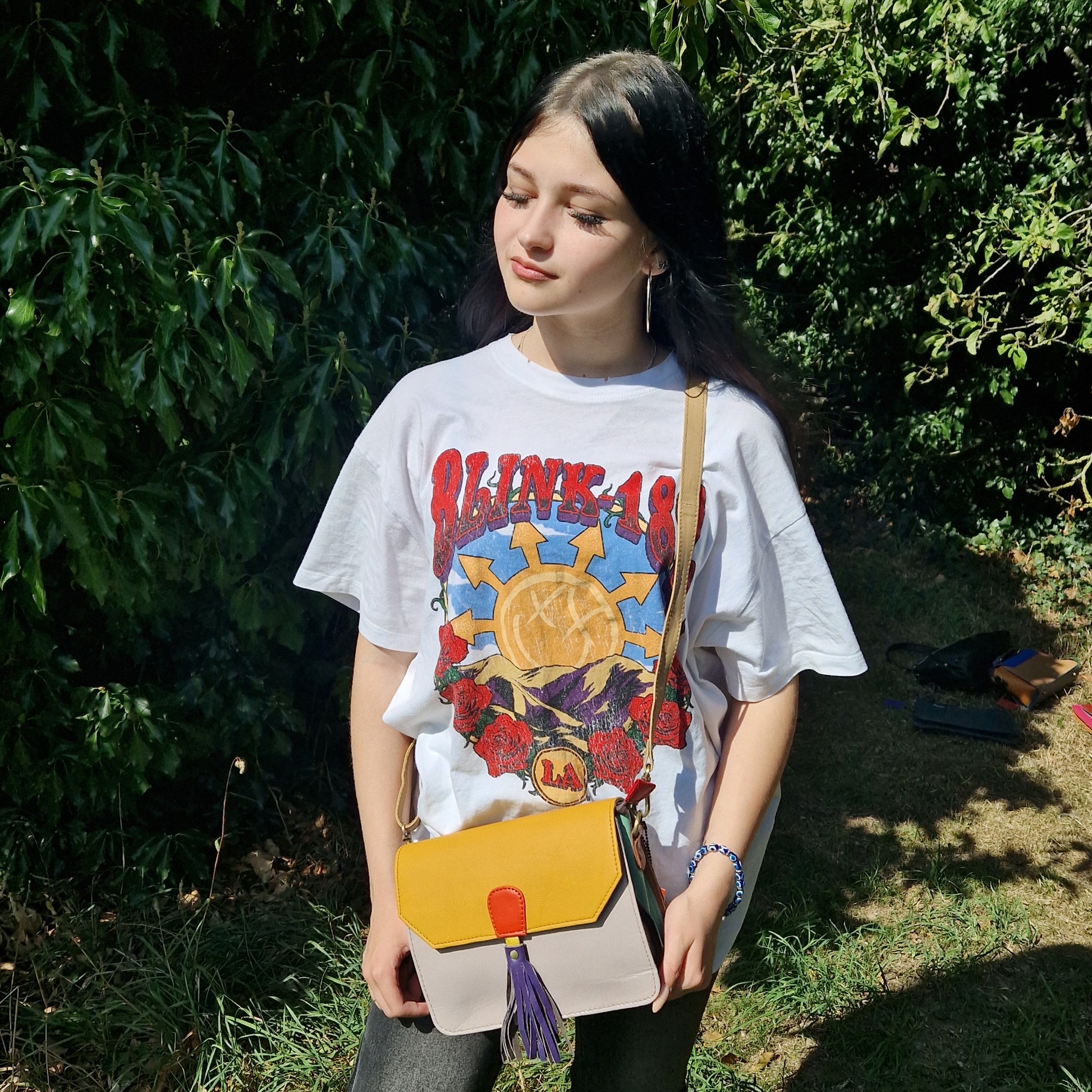 Model wearing Sassy Spirit Pushpa all leather bag in yellow and taupe colours.