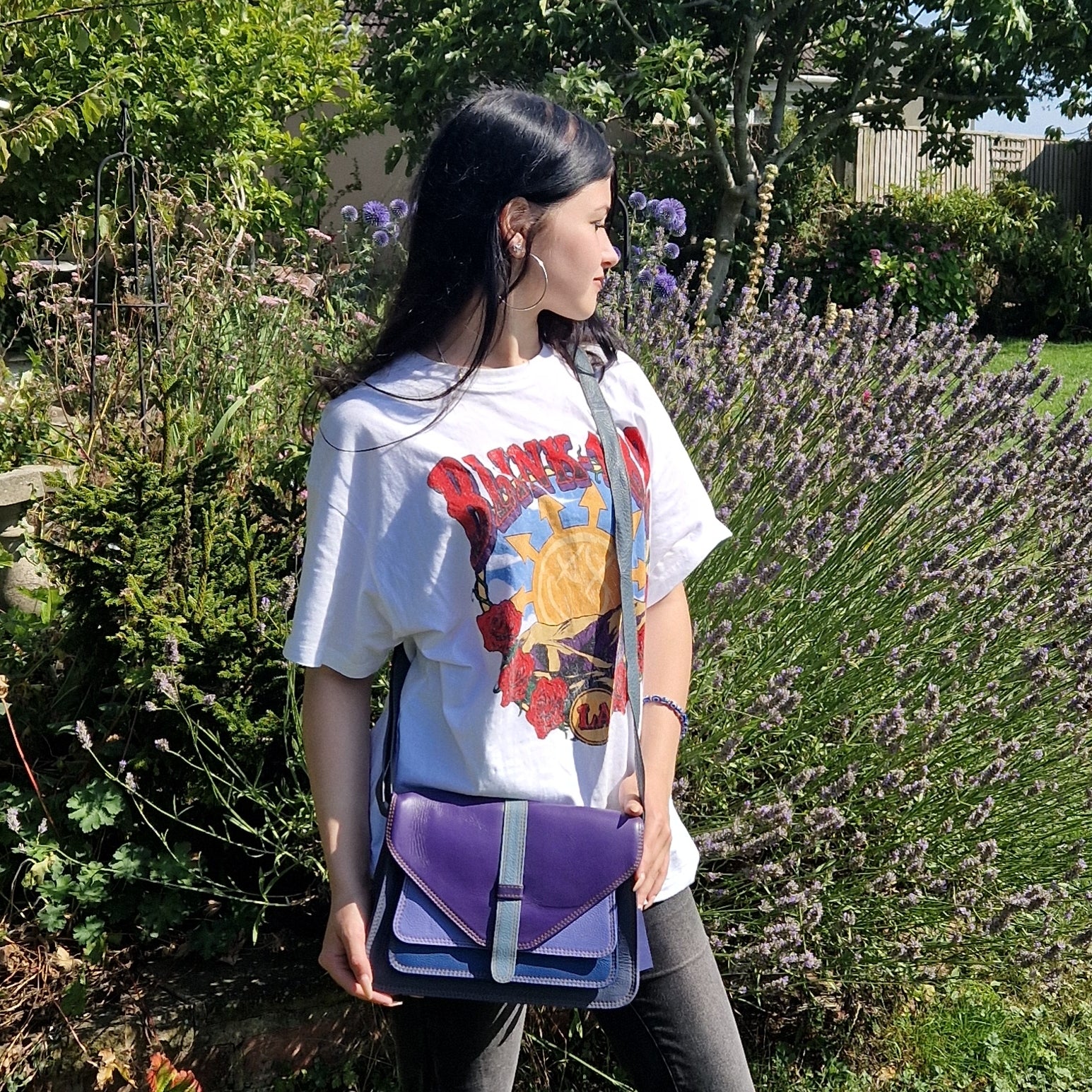 Model with Sassy Spirit Yamini ll leather bag in blue and purple tones.