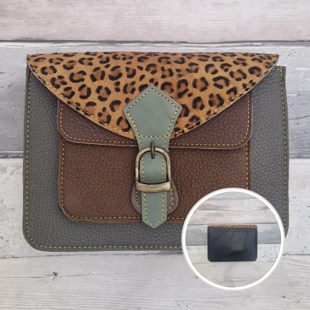 Mini satchel style crossbody bag made with in dark grey with contrasting coloured panels, a buckle closing tab and a textured panel of cheetah print.