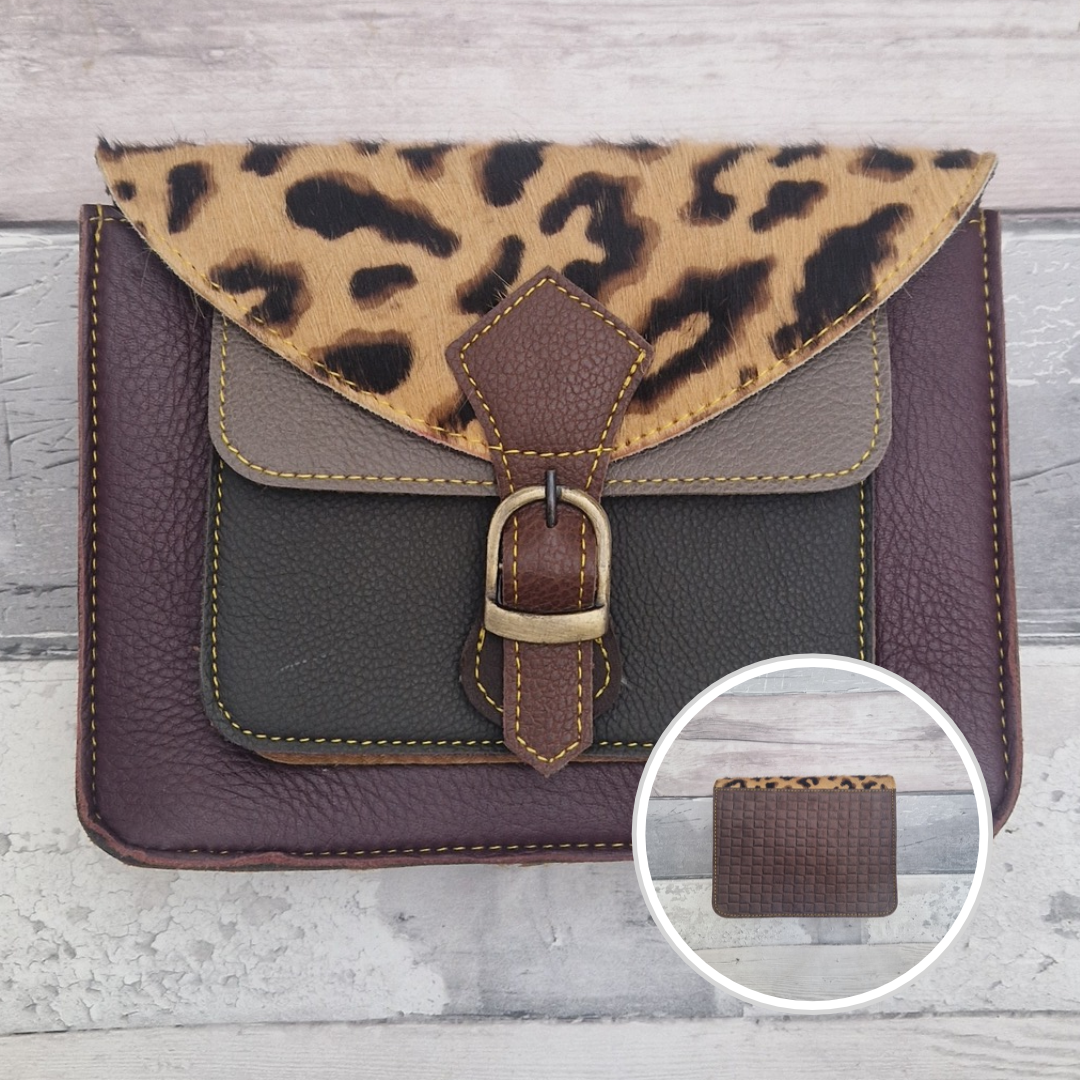 Mini satchel style crossbody bag made with in rich burgundy with contrasting coloured panels, a buckle closing tab and a textured panel of ocelot print.