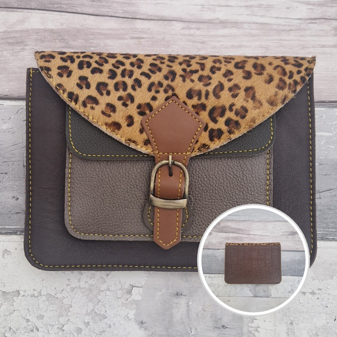 Mini satchel style crossbody bag made with in dark brown with contrasting coloured panels, a buckle closing tab and a textured panel of leopard print.