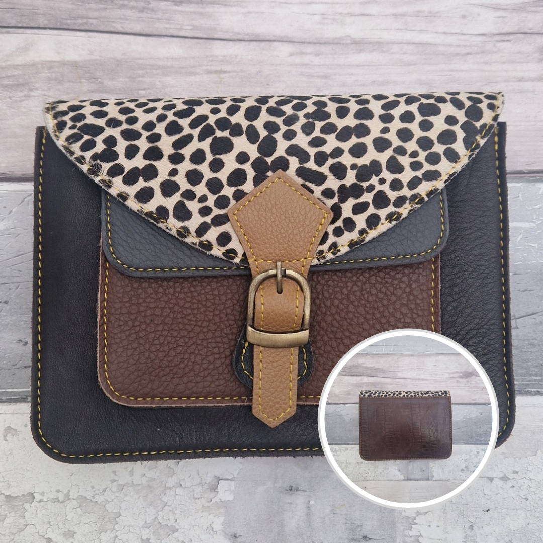 Mini satchel style crossbody bag made with in dark brown with contrasting coloured panels, a buckle closing tab and a textured panel of spot print.