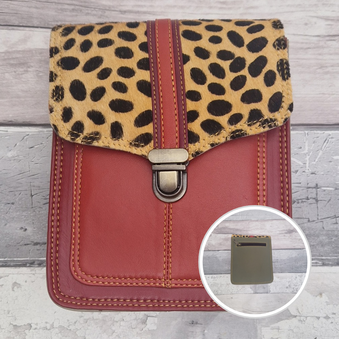Red leather crossbody bag with a textured panel of spot print. Accessed via a push clasp.
