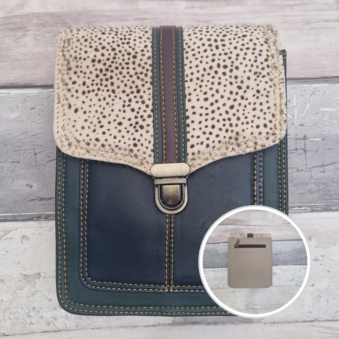 Turquoise leather crossbody bag with a textured panel of spot print. Accessed via a push clasp.