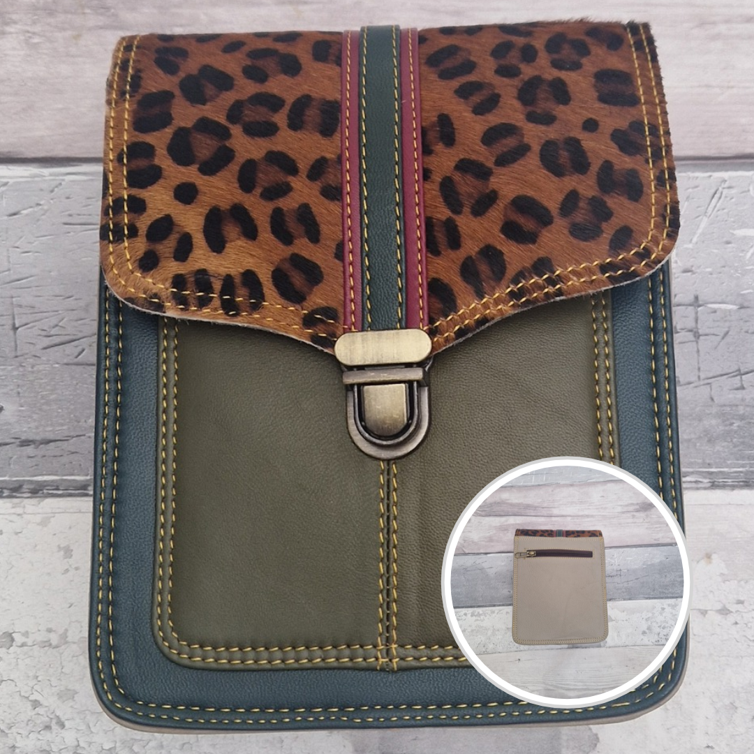 Turquoise leather crossbody bag with a textured panel of cheetah print. Accessed via a push clasp.