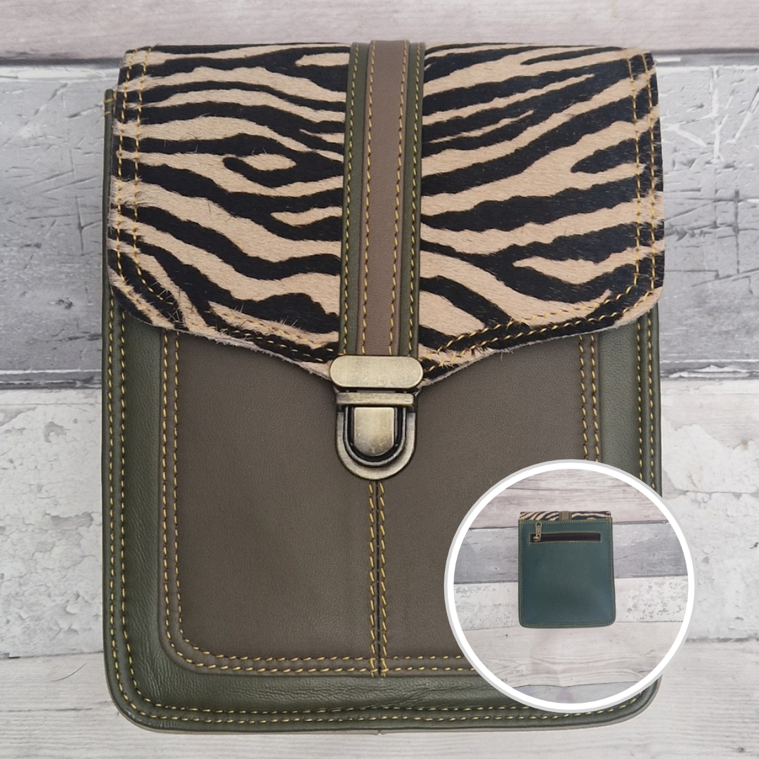 Green leather crossbody bag with a textured panel of zebra print. Accessed via a push clasp.