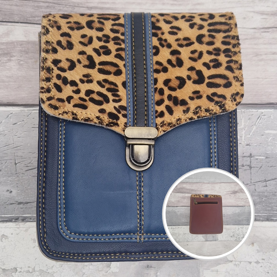 Blue leather crossbody bag with a textured panel of leopard print. Accessed via a push clasp.