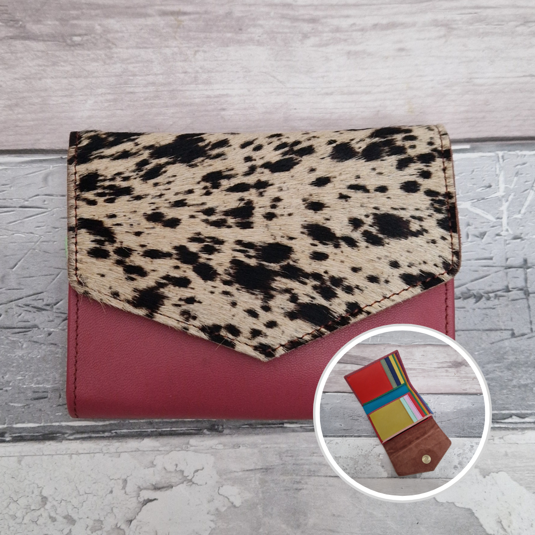 Pink leather fold out purse with a textured pony print front panel and multi-coloured interior.