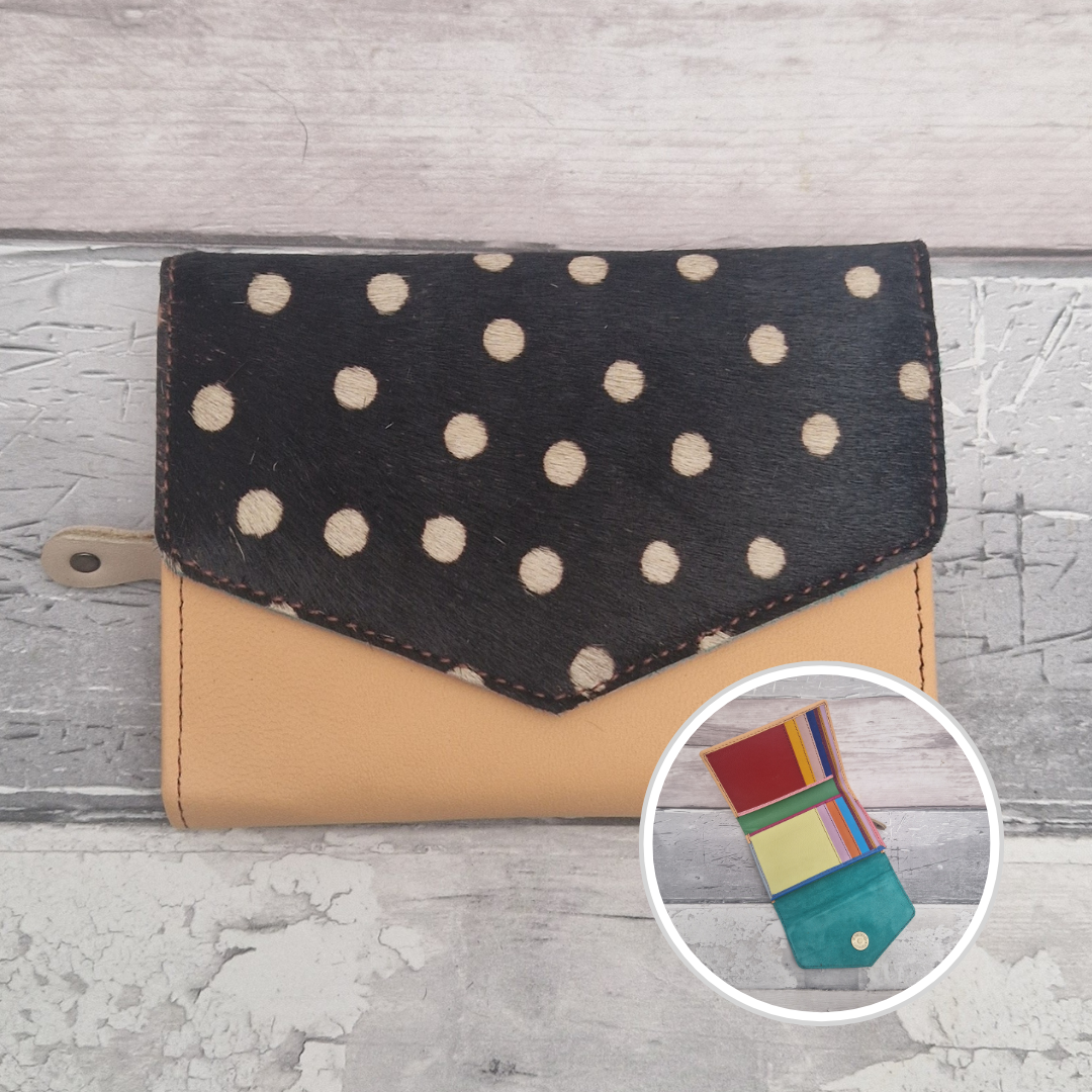 Peach leather purse with a textured panel of spotty print.