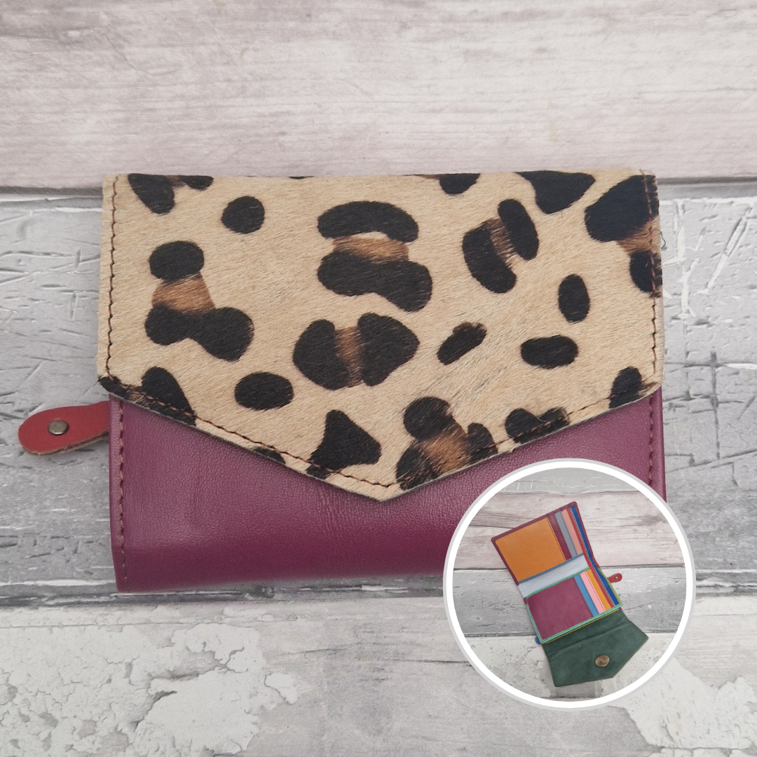 Burgundy leather purse with a textured panel of leopard print.