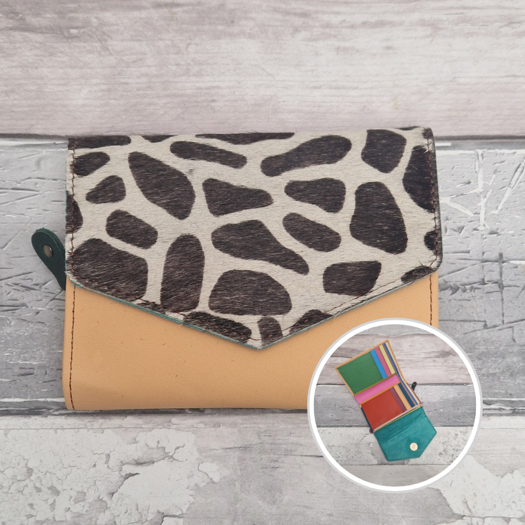 Peach leather purse with a textured panel of giraffe print.