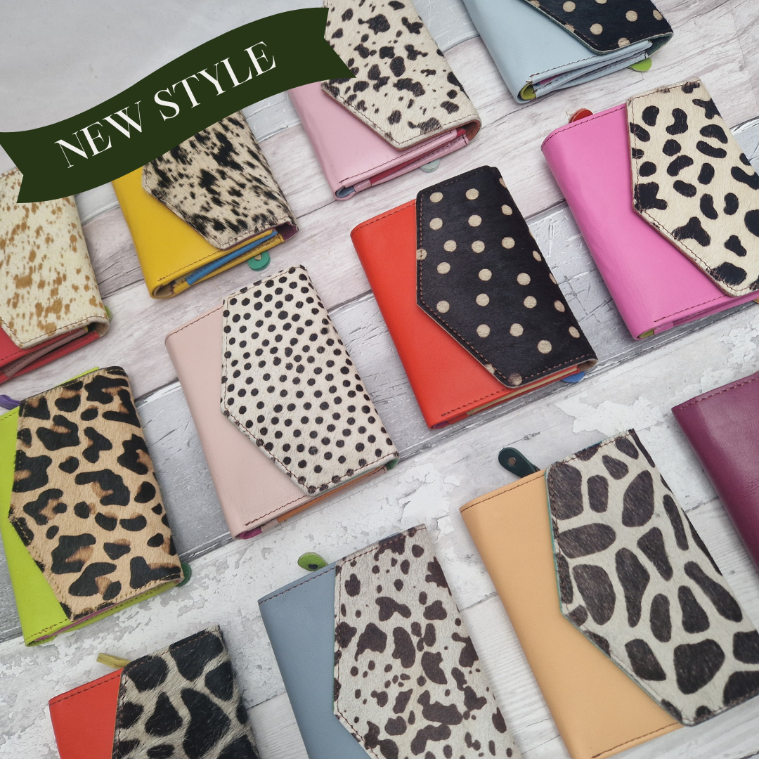 Collection of brightly coloured leather purses with animal print panels.