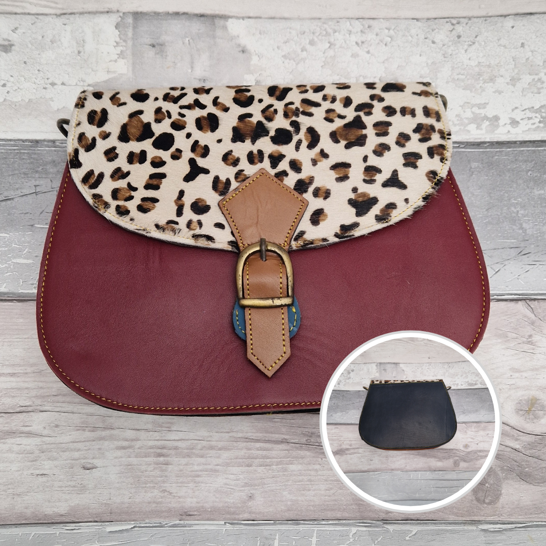 All leather saddlebag style bag in dark red with a textured panel of leopard Animal Print.