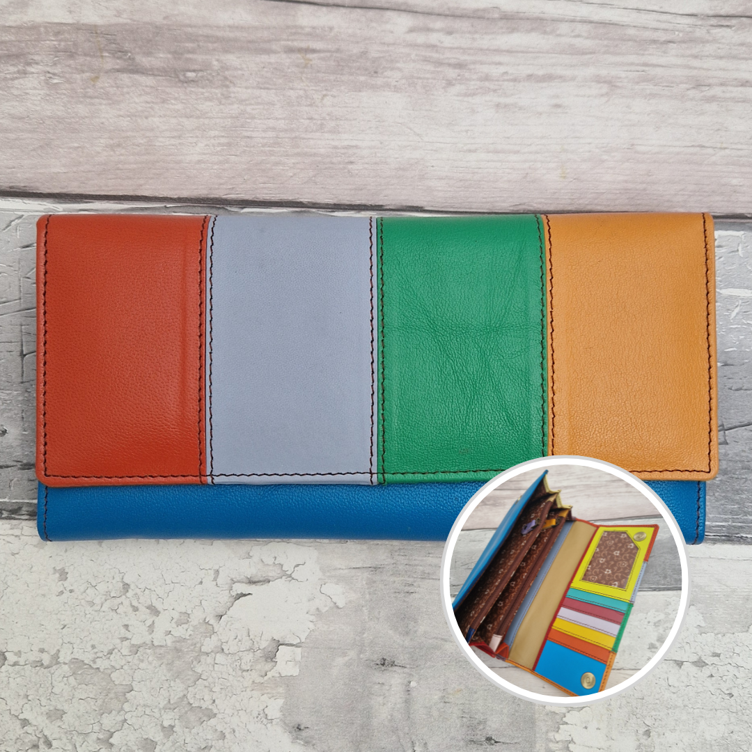 A multi-colored leather wallet with vertical color-blocked panels in orange, light gray, green, and tan, with a blue base. A circular inset shows the interior card slots containing cards.