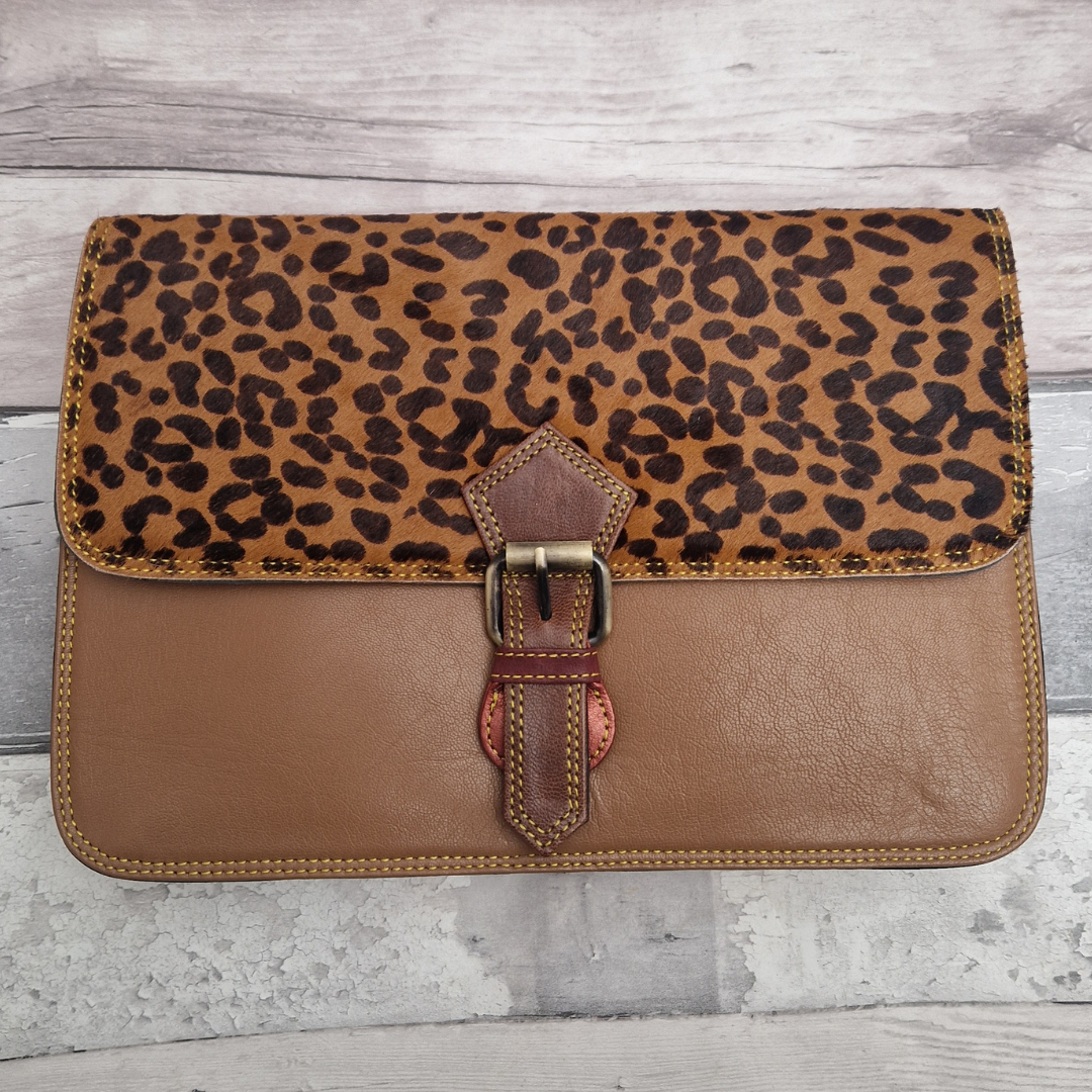 Brown Leather envelope style bag with textured panel of cheetah print and buckle clasp.