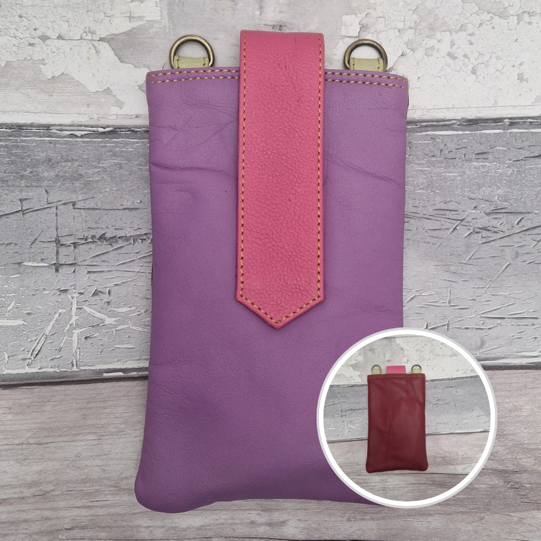 Purple leather pouch with pink accent and gold rings on a textured surface