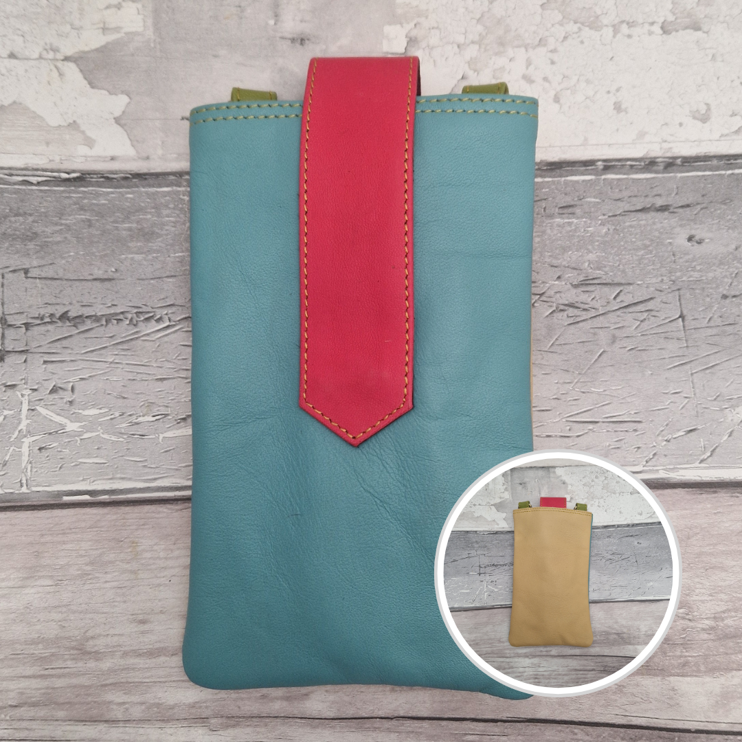 Teal phone pouch with red accent on a wooden surface