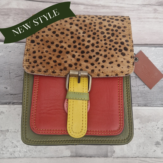 All leather mini satchel style bag with green and orange panel finished with a textured wild spot animal print.