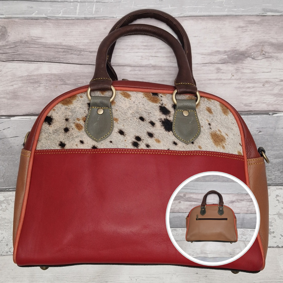 Bowling bag style handbag made from multi-coloured leather pieces. Textured panel of cow hide features.