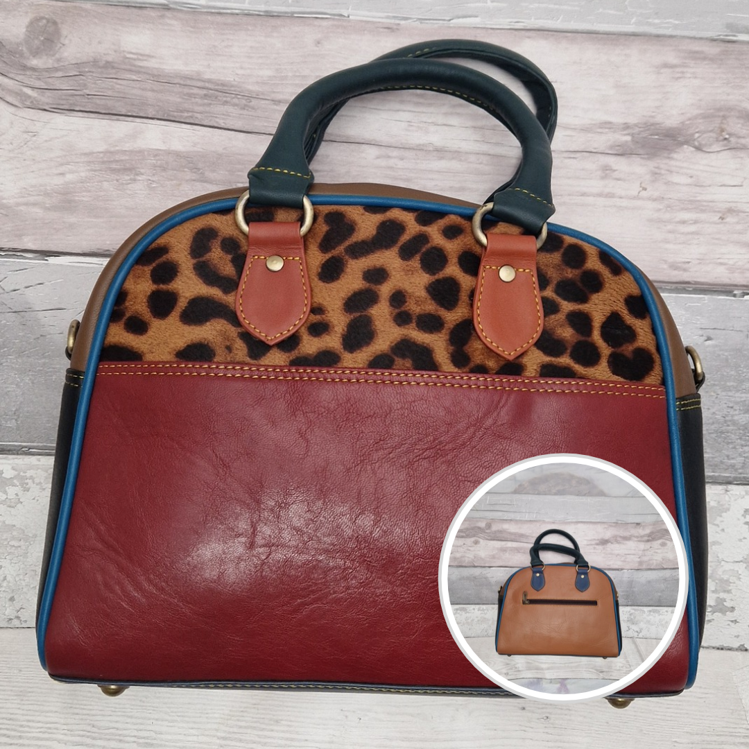 Bowling bag style handbag made from multi-coloured leather pieces. Textured panel of cow hide has been decorated with a striking leopard print.