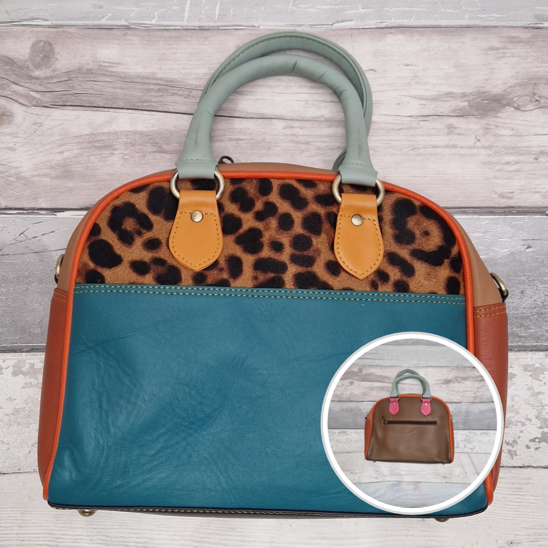 Bowling bag style handbag made from multi-coloured leather pieces. Textured panel of cow hide has been decorated with a striking leopard print.