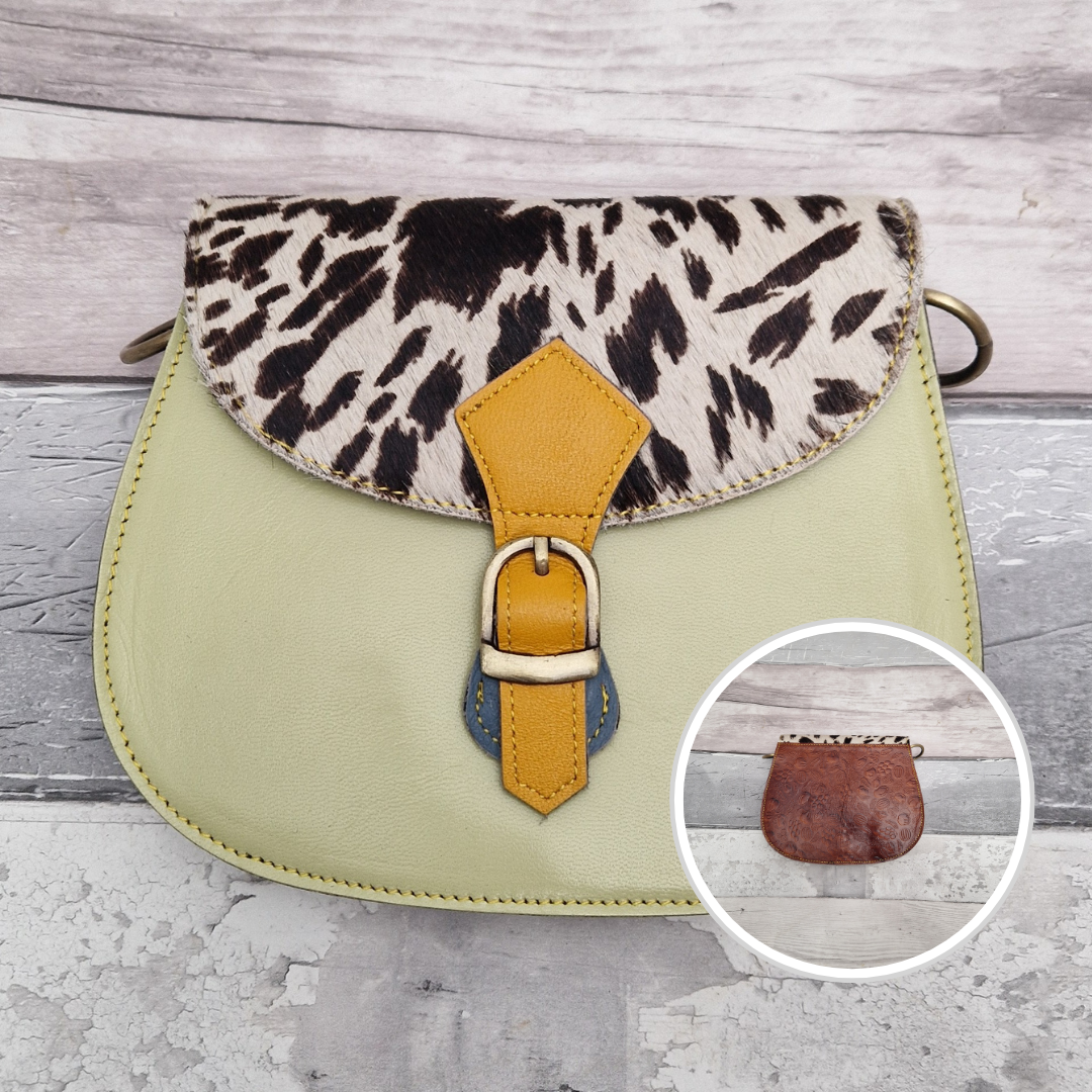 Leather saddlebag shaped bag with a pistachio front and a textured panel of wild animal print.