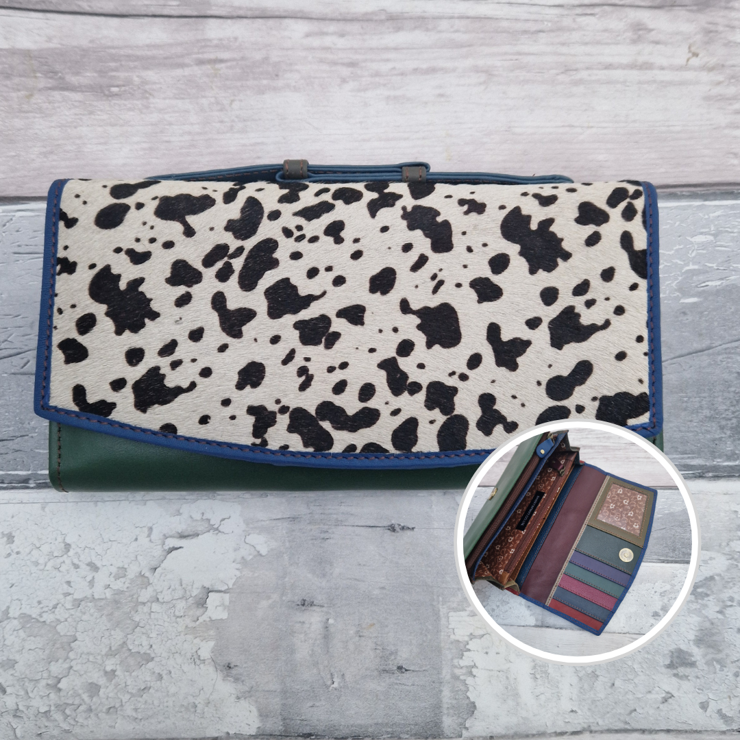 All leather purse with a bottle green and blue coloured exterior and textured panel of cow print.