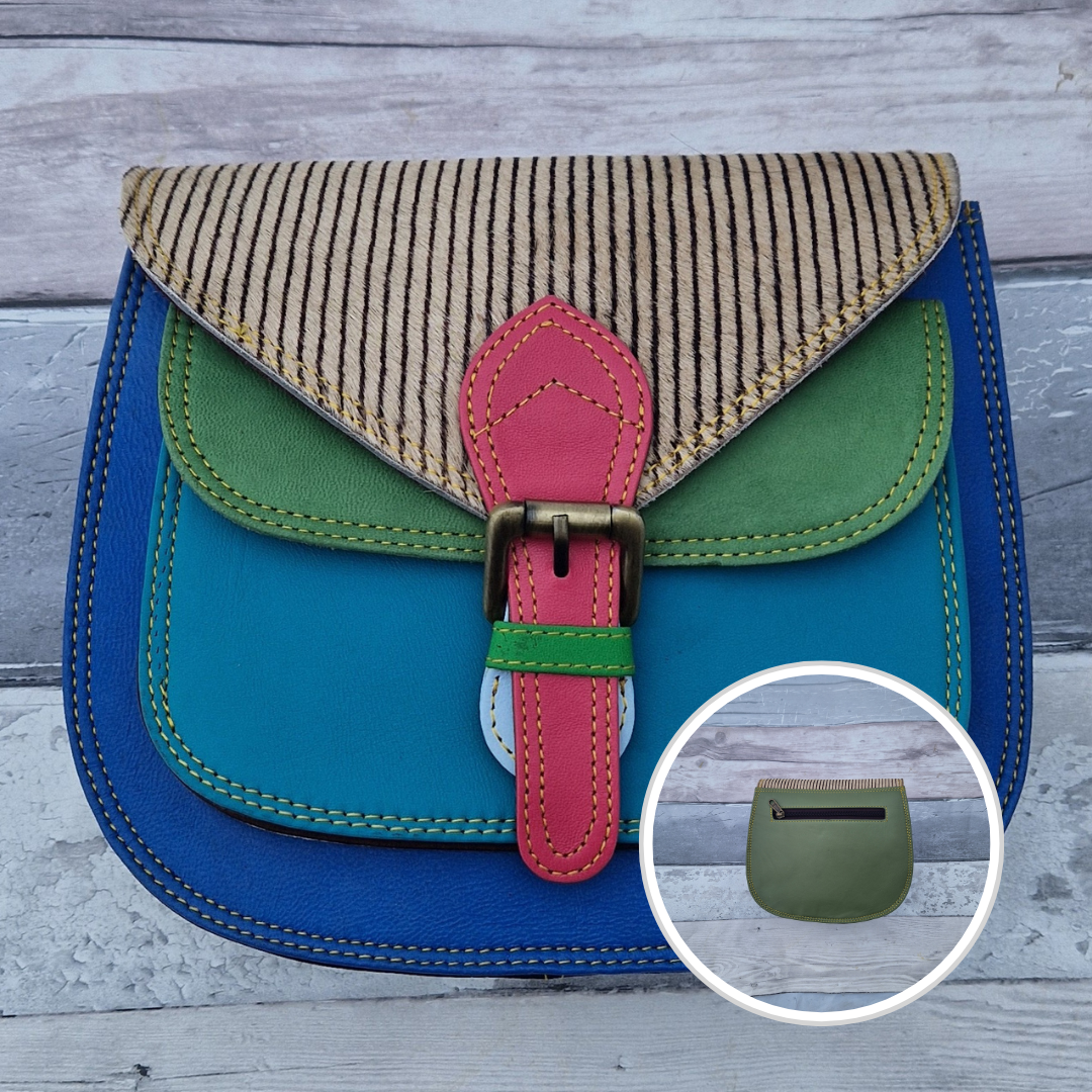 Saddlebag style bag in electric blue leather with contrasting coloured panels and a section of textured striped print.