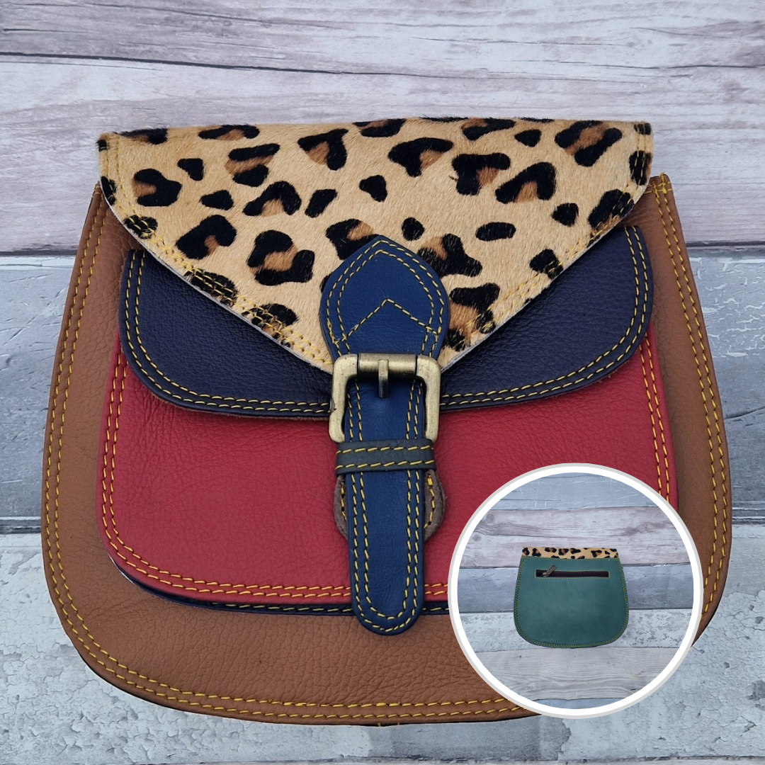 Saddlebag style bag in tan coloured leather with contrasting coloured panels and a section of textured leopard print