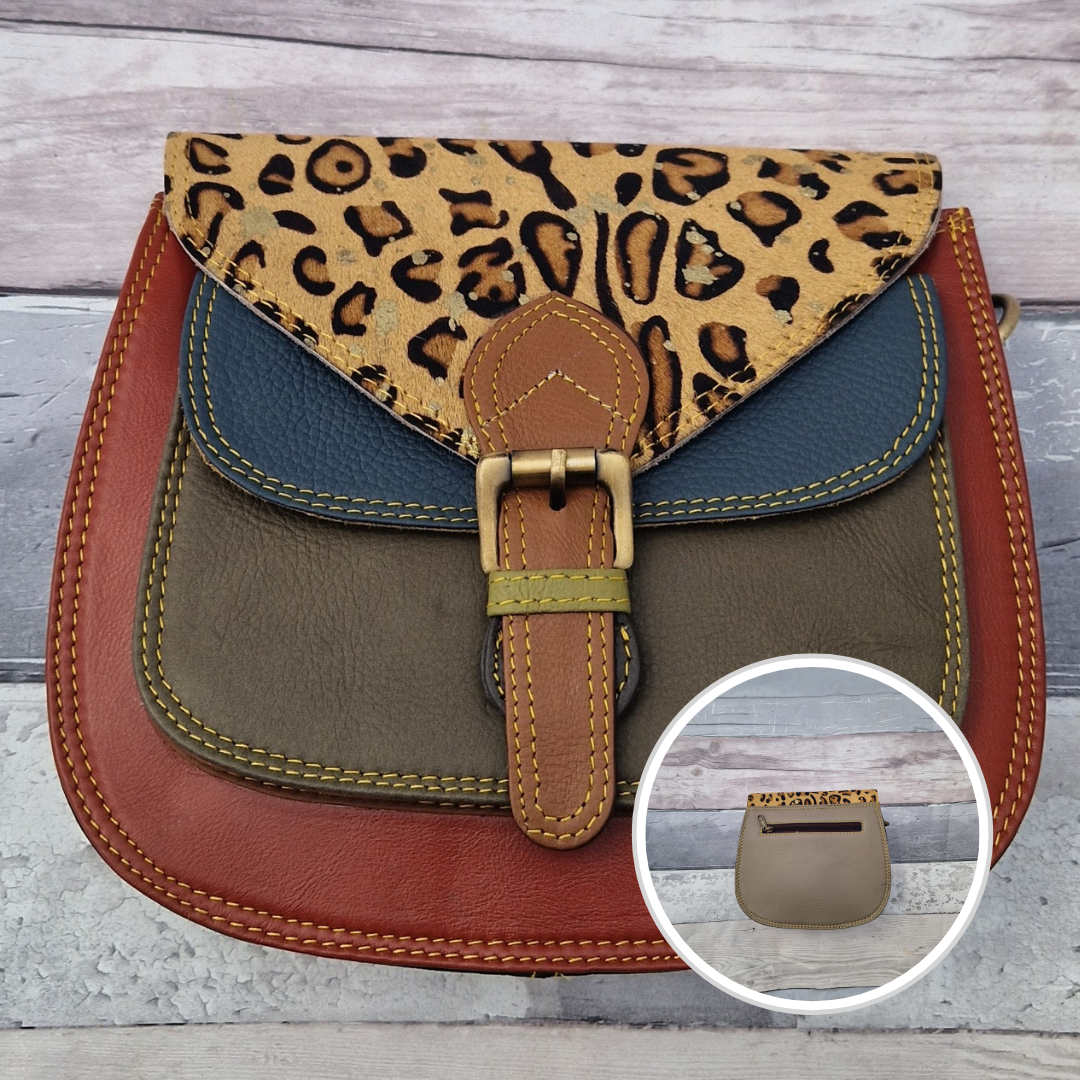 Saddlebag style bag in rust red coloured leather with contrasting coloured panels and a section of textured leopard print